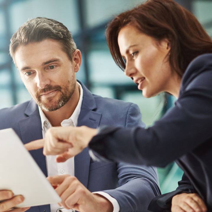 An executive man and a woman talking to each other